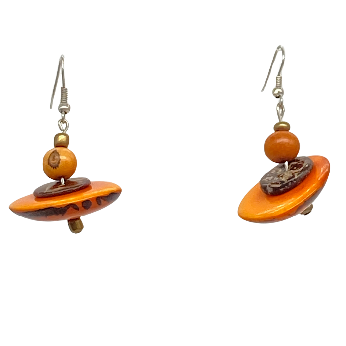 Dangle earring composed of an irregular shaped piece of Tagua nut, a bead of coconut shell, and a tiny bead of acai berry